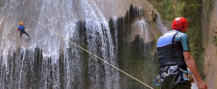 Image of two persons when canyoning in falls.